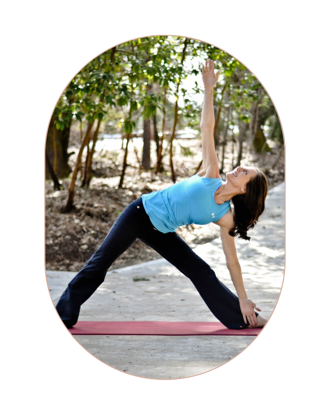 Woman practicing yoga outdoors on a pink mat, stretching with one arm raised and one hand on the ground, surrounded by trees and natural scenery.