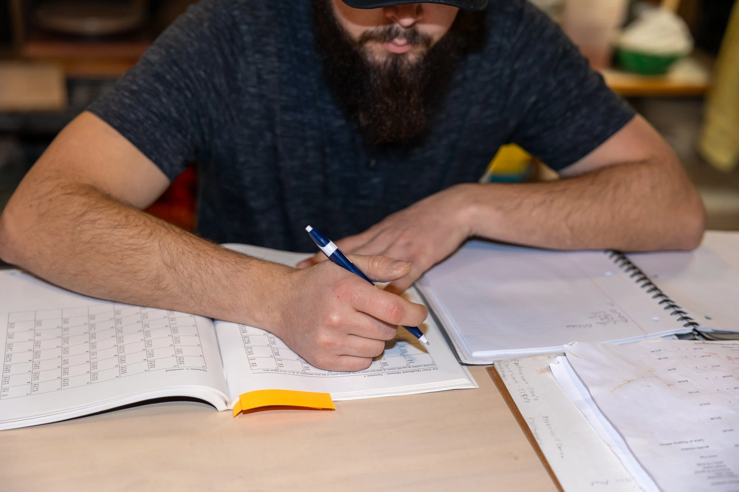 Adam Corbridge writing notes in a glaze notebook