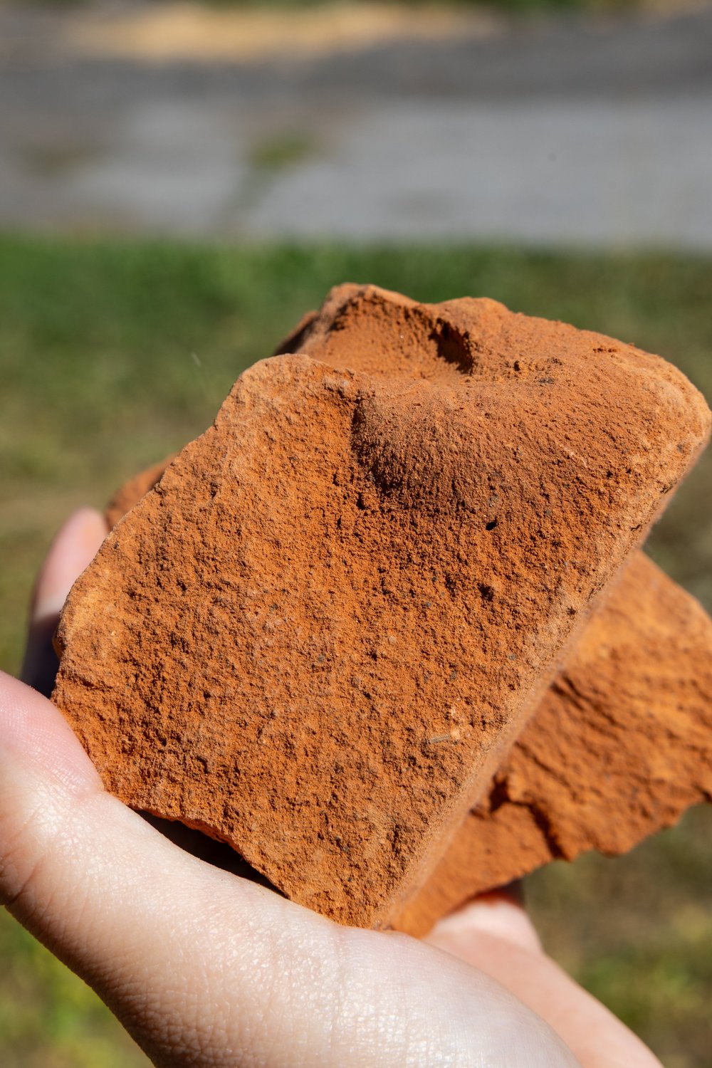 Red Utah clay held in a hand