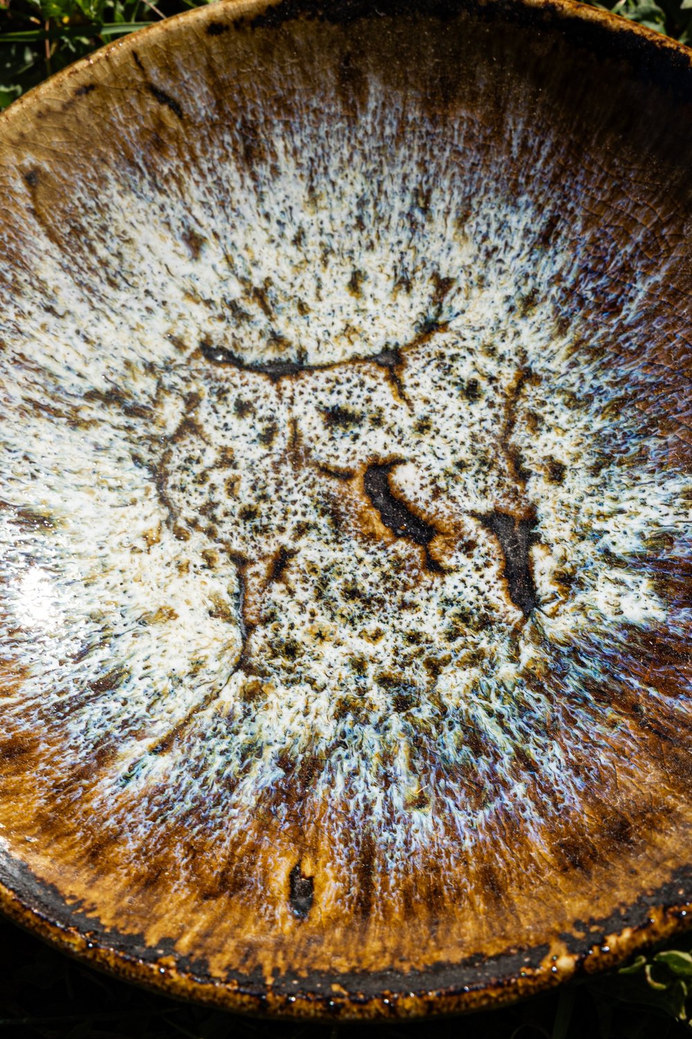 Looking into a salt-fired bowl with a white and amber speckled interior