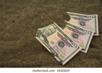 Three American dollar bills, including a ten and a fifty dollar note, placed on a dark surface.