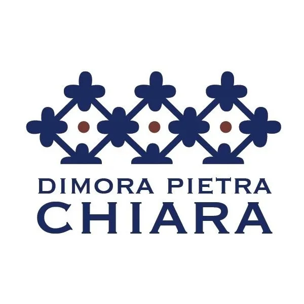 Logo with a decorative floral pattern above the text "Dimora Pietra Chiara" in navy blue.