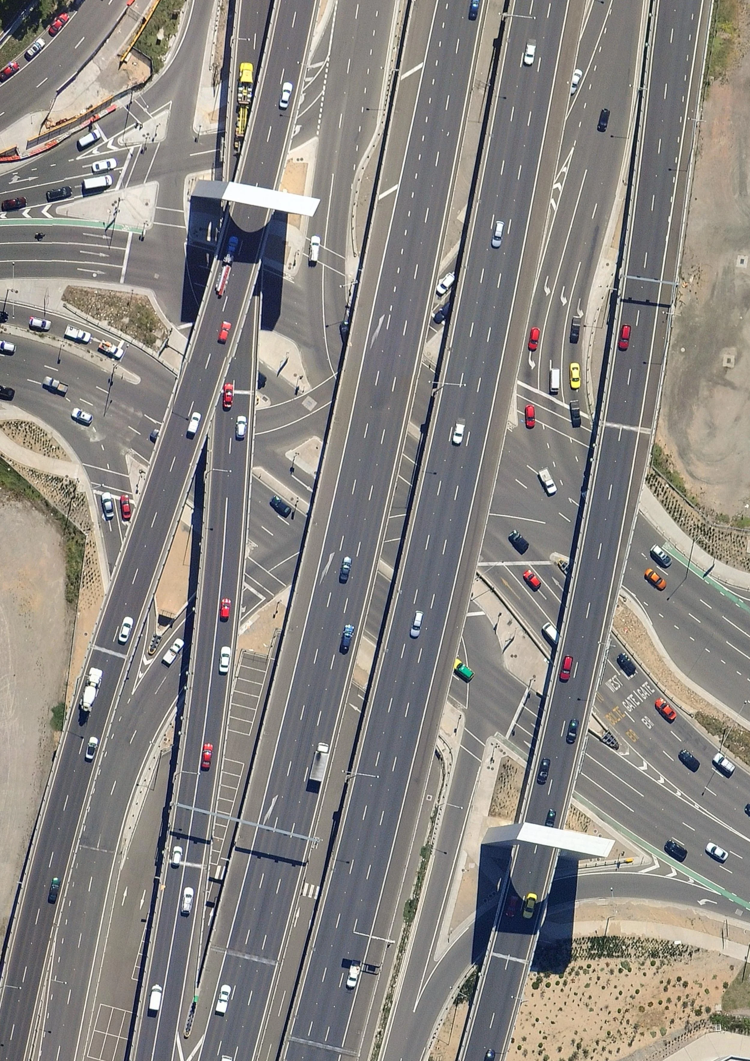 An aerial view of multiple highways and overpasses with various cars traveling on them.