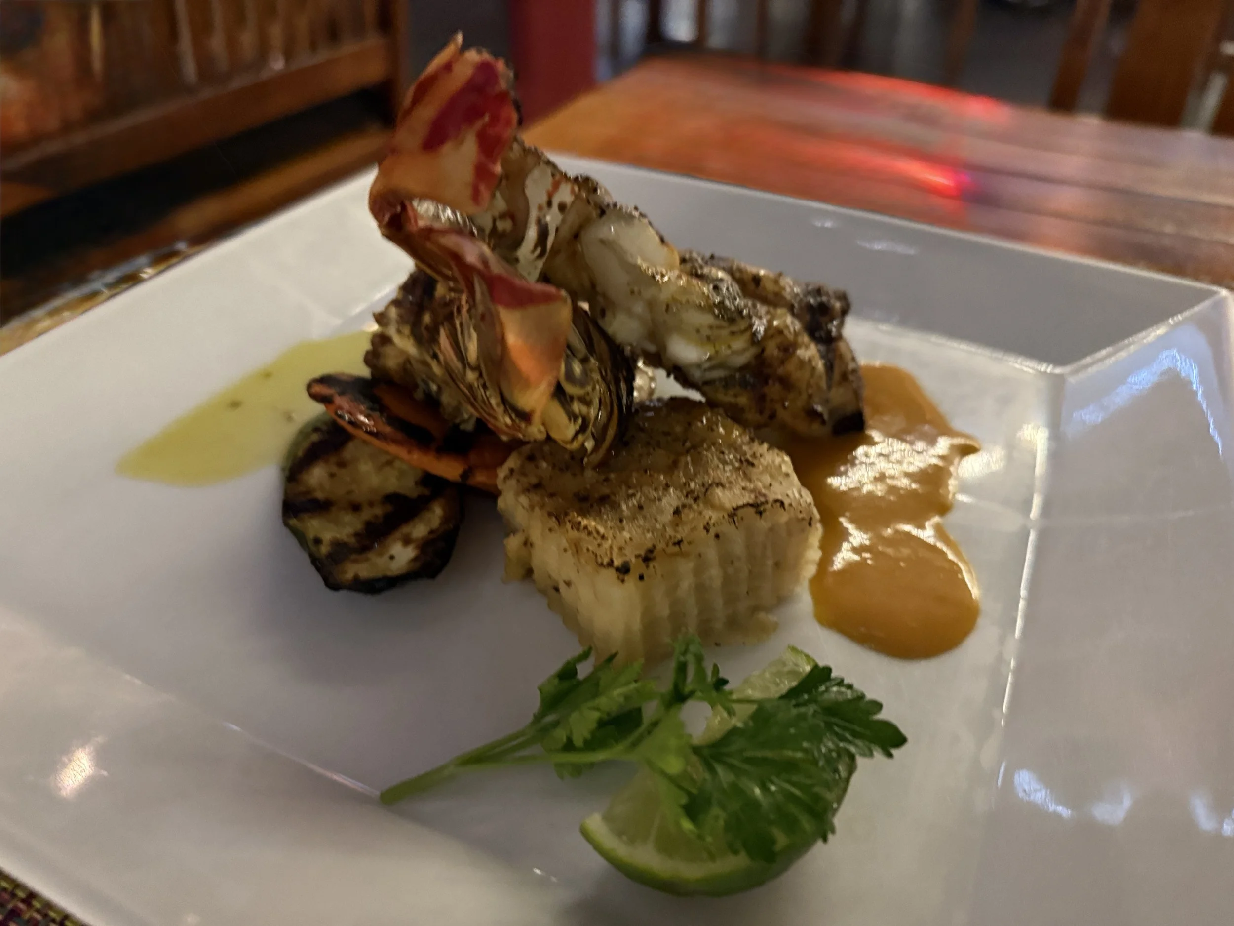 Grilled Lobster tail with mashed potatoes and sauce at Caicos Cafe in Turks and Caicos