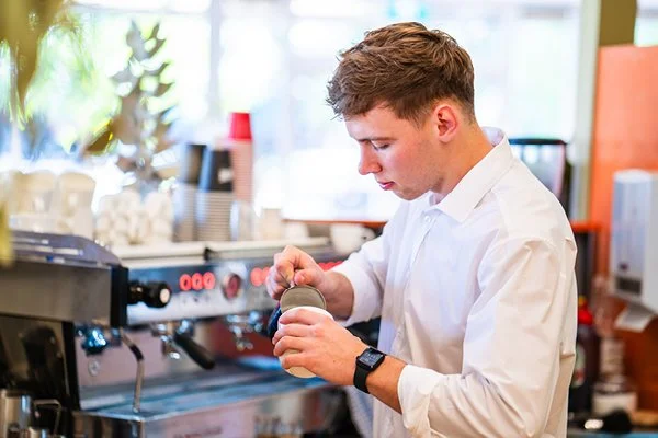 Male pouring coffee at Spoons Riverside