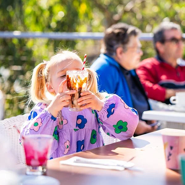 Girl drinking chocolate milkshake Spoons Riverside