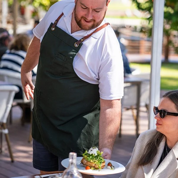 Spoons Riverside staff delivering food to table