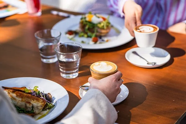 Spoons Riverside two meals on plates with two customers drinking coffee