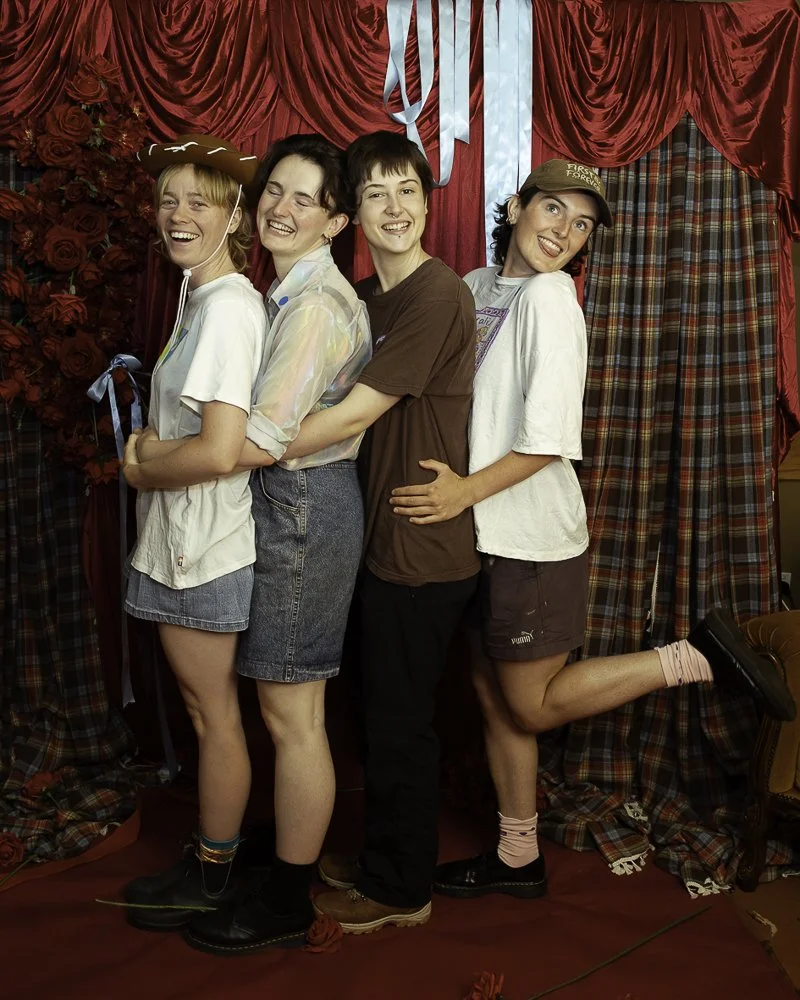 A large metal axe with a wooden handle resting on a table covered with a black cloth. In the background, there are various knickknacks and decorative items.