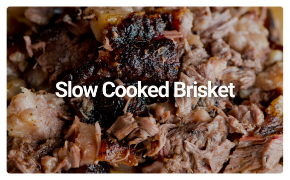 Close-up of shredded, slow-cooked beef brisket with crispy edges.