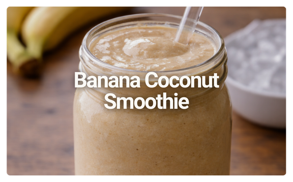 Banana coconut smoothie in a glass jar with a straw on a wooden table.