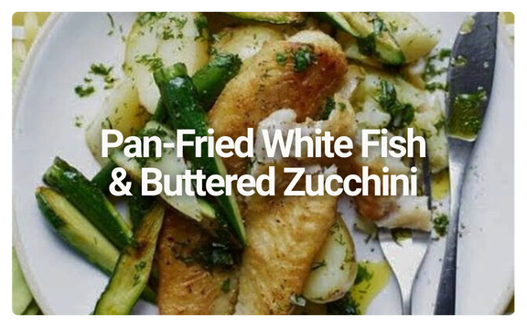 Plate with pan-fried white fish, buttered zucchini, and potatoes. Text overlay says "Pan-Fried White Fish & Buttered Zucchini."