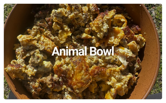 Animal bowl filled with scrambled eggs, ground meat, and cheese.