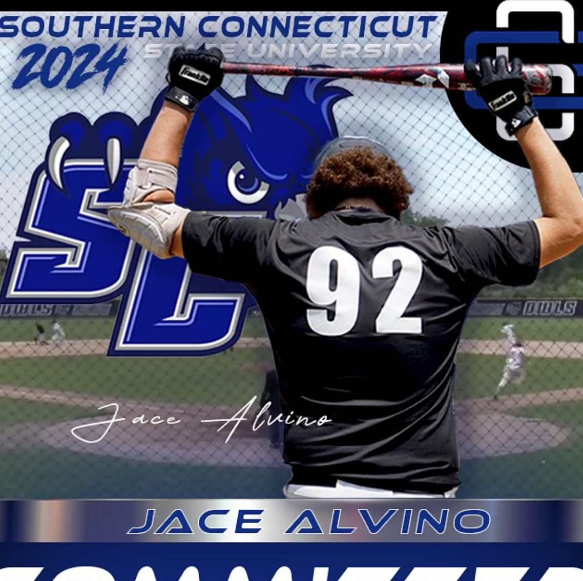 A baseball player with jersey number 92 in a black uniform celebrates at Southern Connecticut State University 2024. The player is holding a baseball bat overhead against a background featuring a blue lion mascot and the university's logo on a fence near a baseball field.