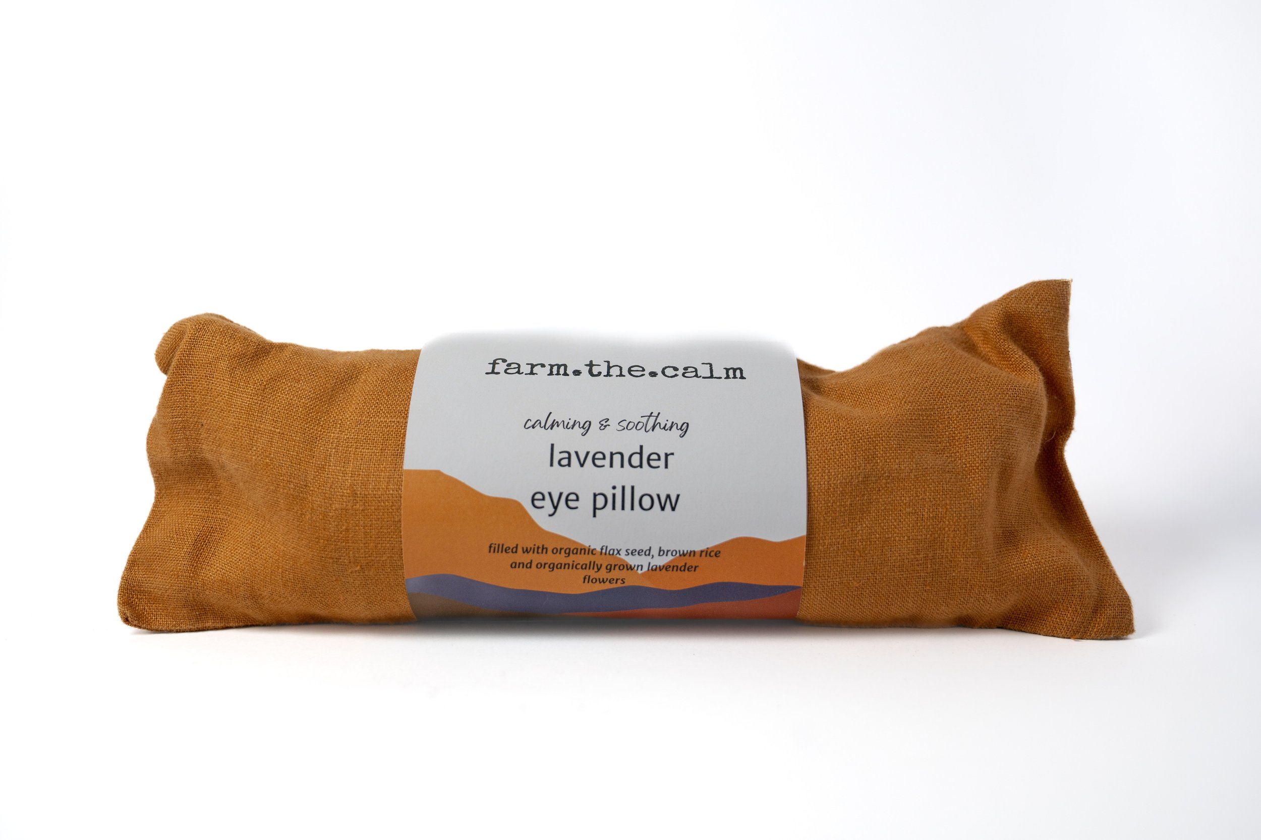 Lavender eye pillow in a brown fabric case with a white label