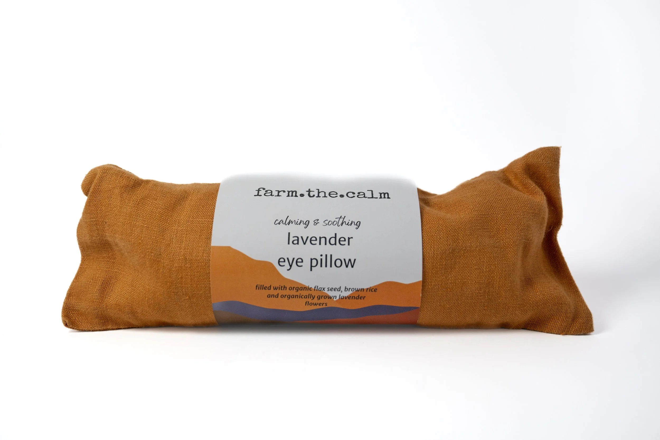Lavender eye pillow in a brown fabric case with a white label that reads 'farm.the.calmm calming & soothing lavender eye pillow' on a white background.
