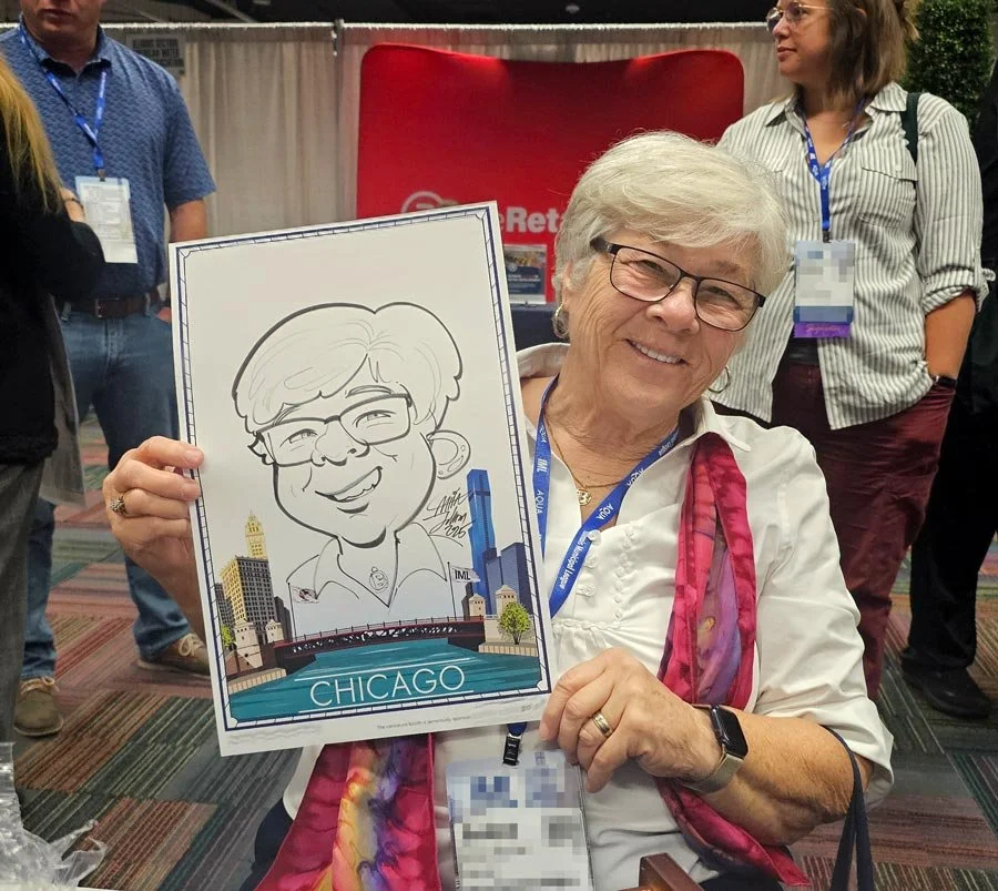 A woman with glasses and white hair holds her caricature with a Chicago river and skyline border.