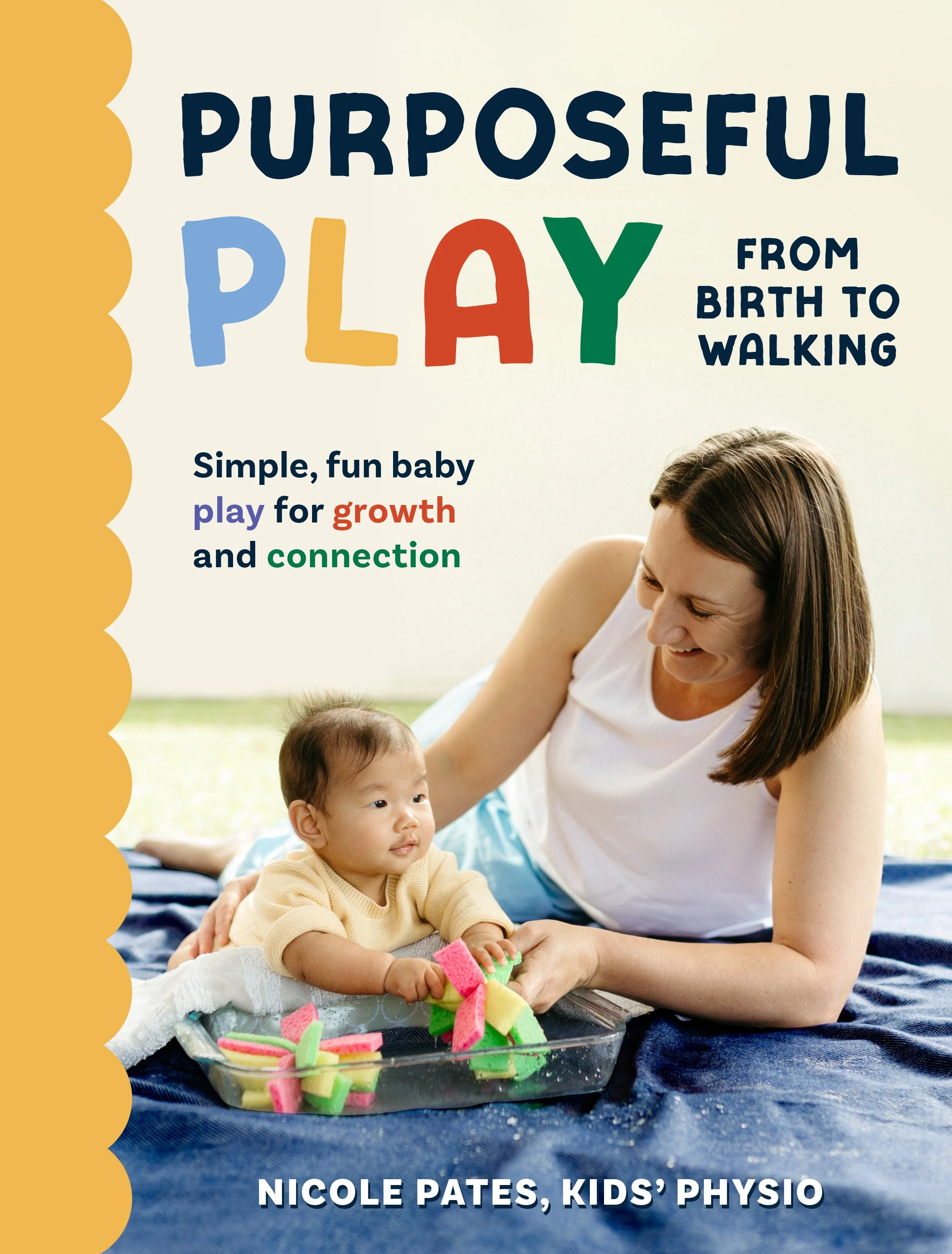 Nicole Pates and a baby playing with colorful foam blocks on a blue blanket outdoors, with a light background.