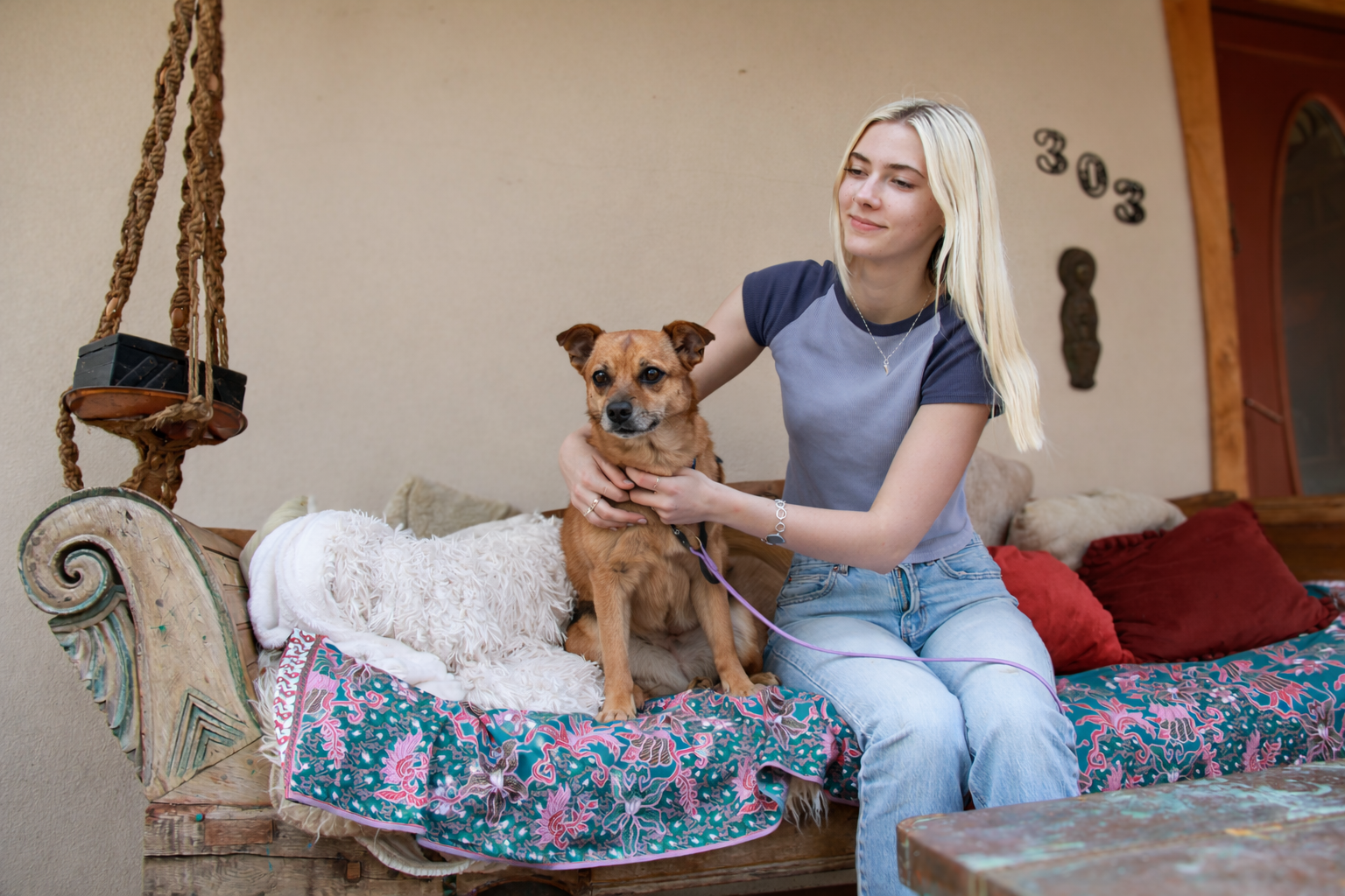 Woman and dog on rustic daybed.png