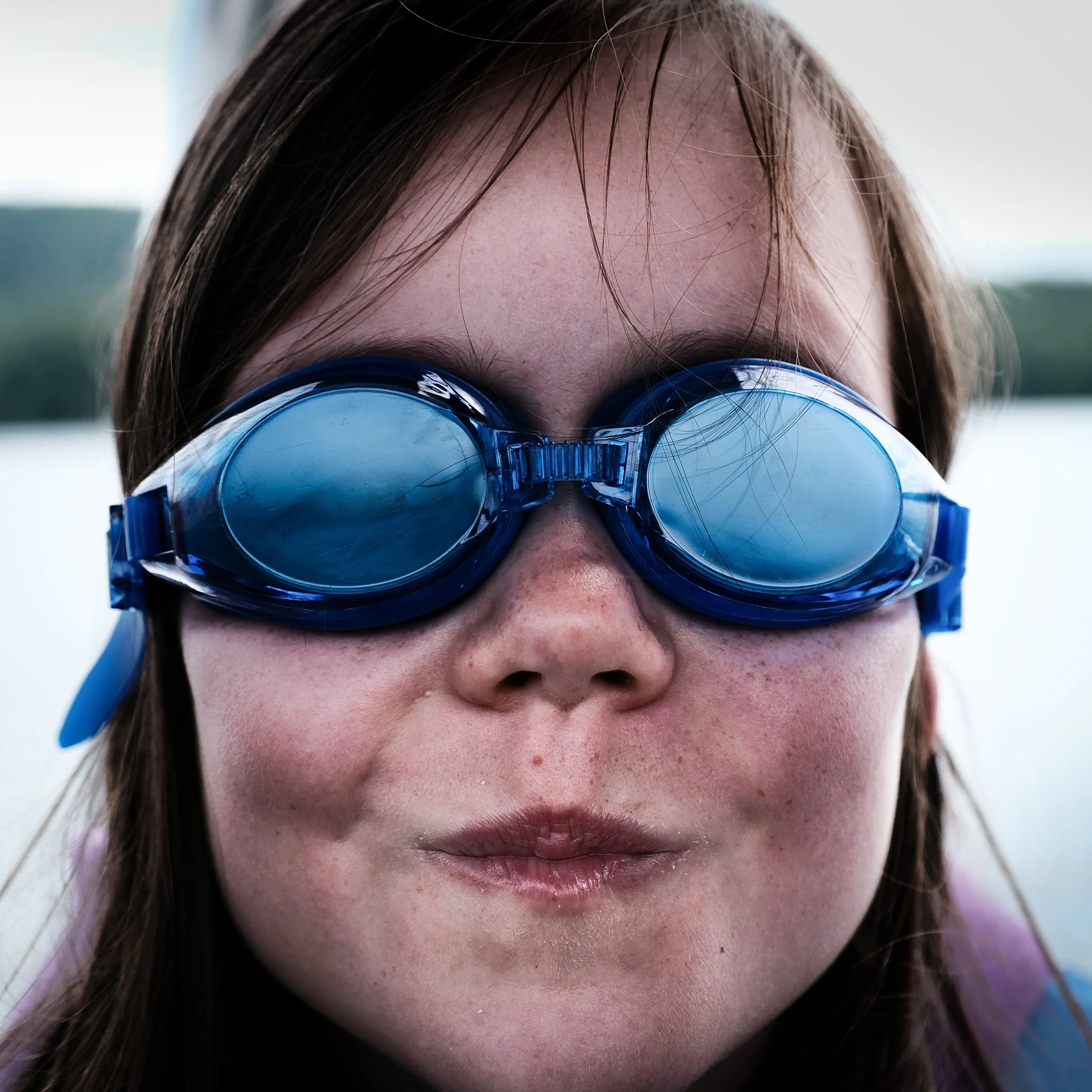 Close-up of a person's face wearing goggles, showing their forehead, nose, and mouth.
