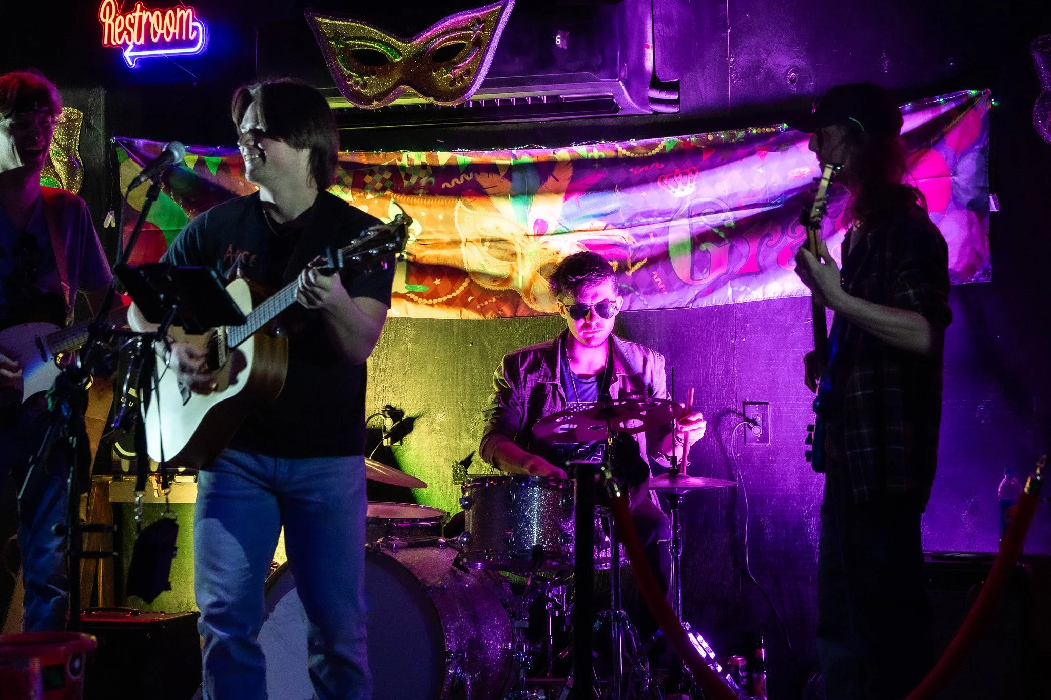 Lost Street Records co-founder performing on drum set with Ty Junah Wellman on guitar under vibrant stage lighting.