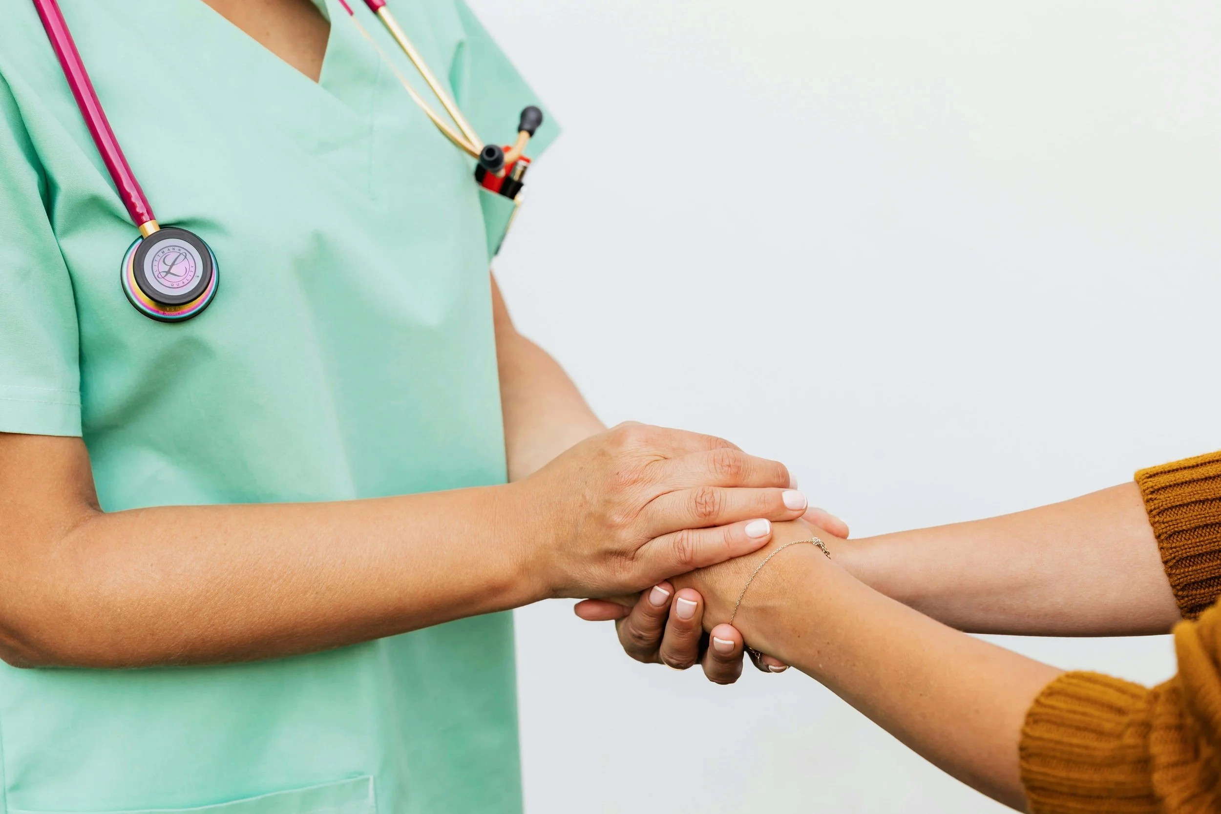 A healthcare professional shaking hands with a patient