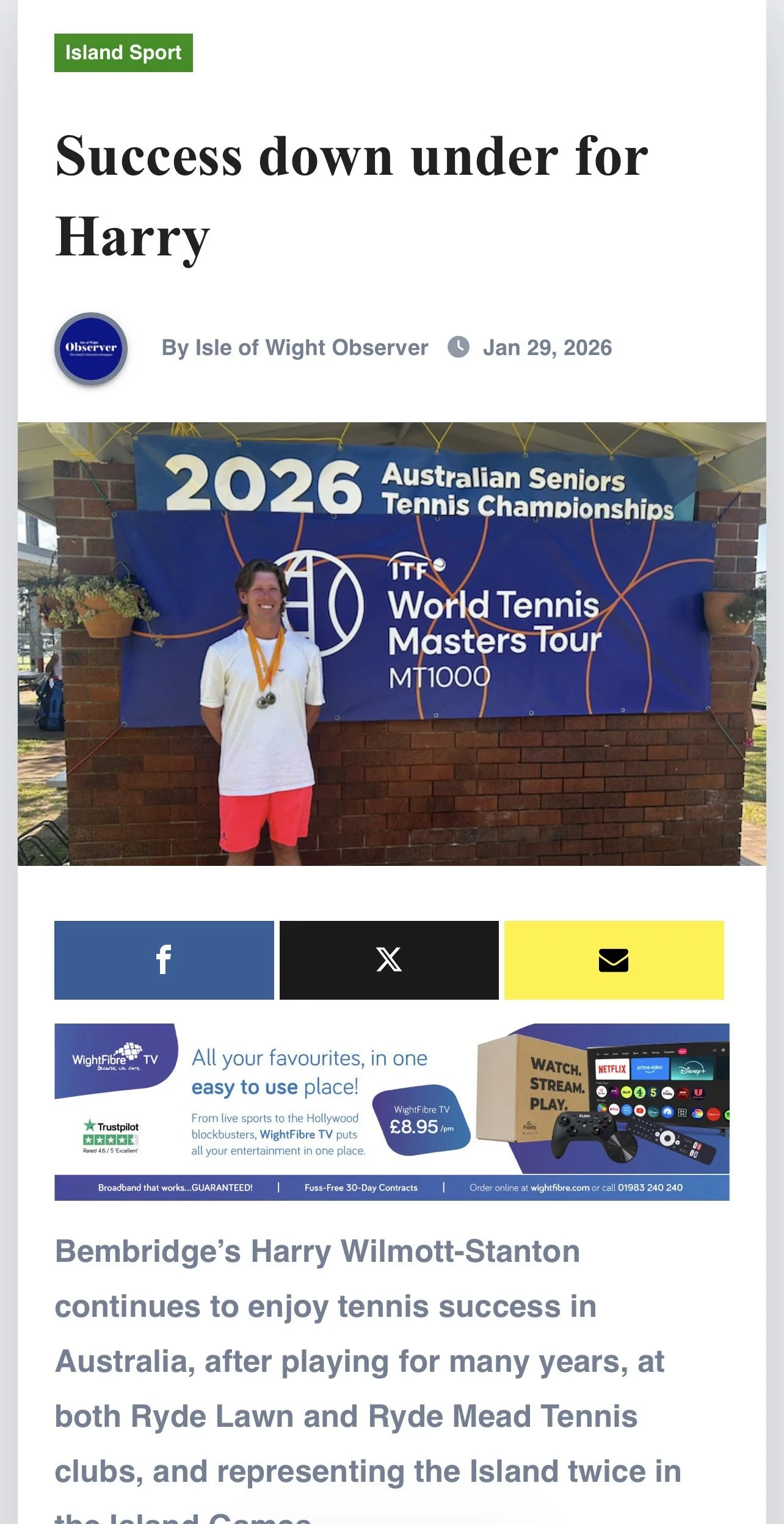 A woman standing in front of a blue banner at the 2026 Australian Seniors Tennis Championships, wearing medals around her neck.