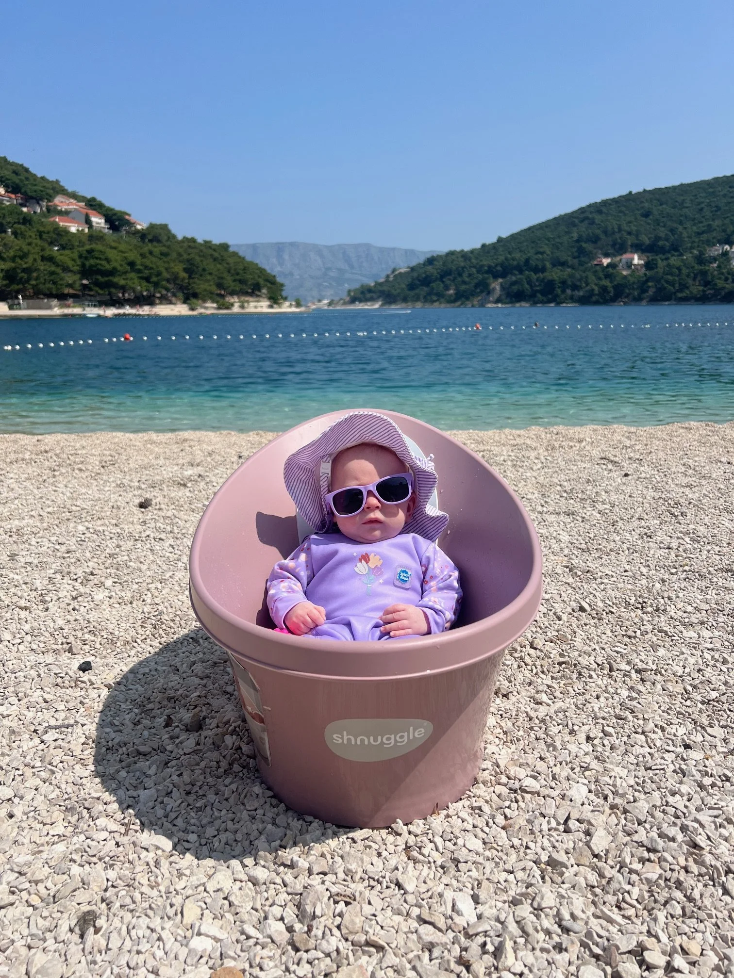 Baby in bath on the beach in Pučišća