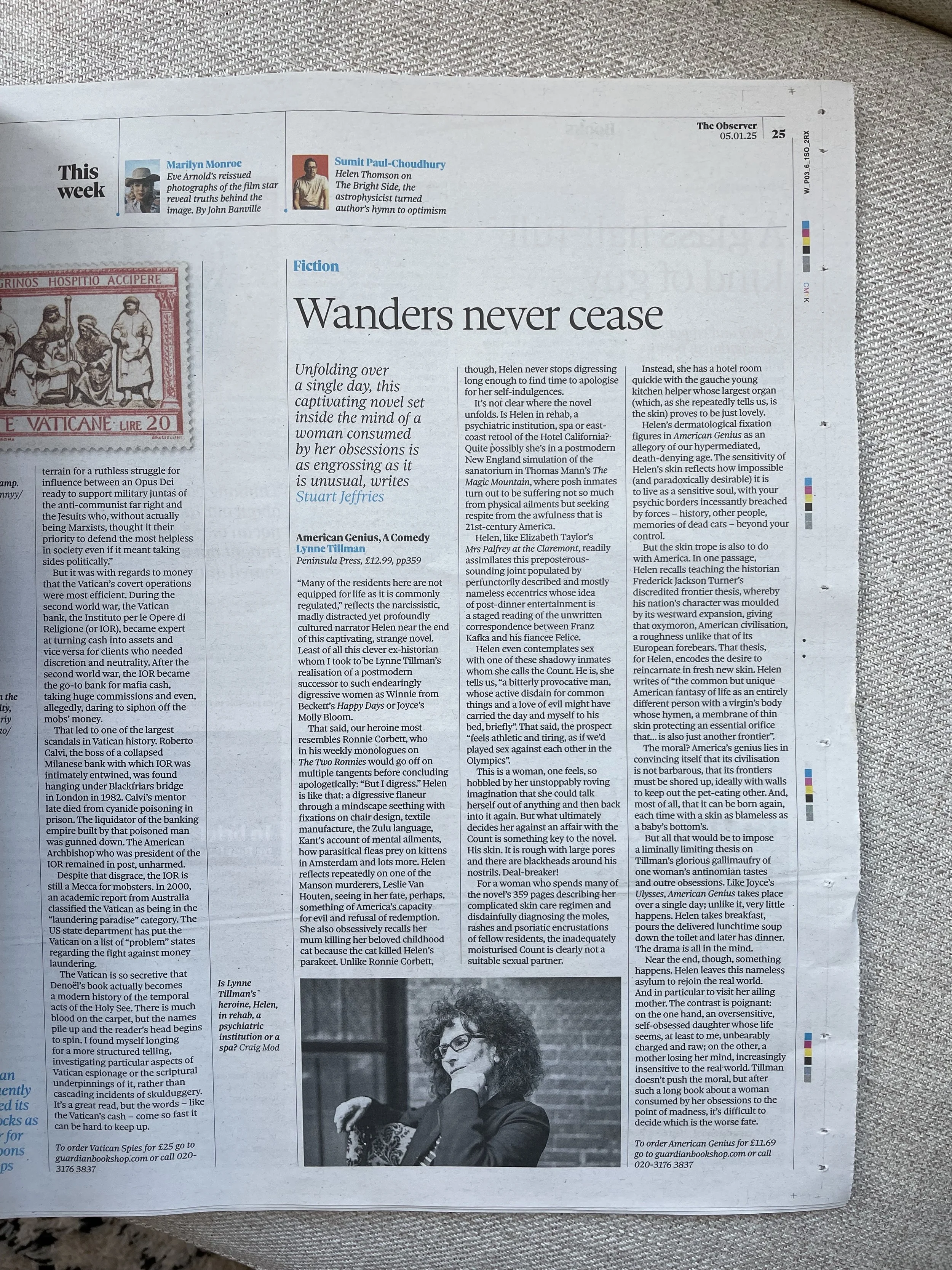 A newspaper page featuring an article titled 'Wanders never cease,' with a black and white photo of a woman with curly hair and glasses, resting her chin on her hand.