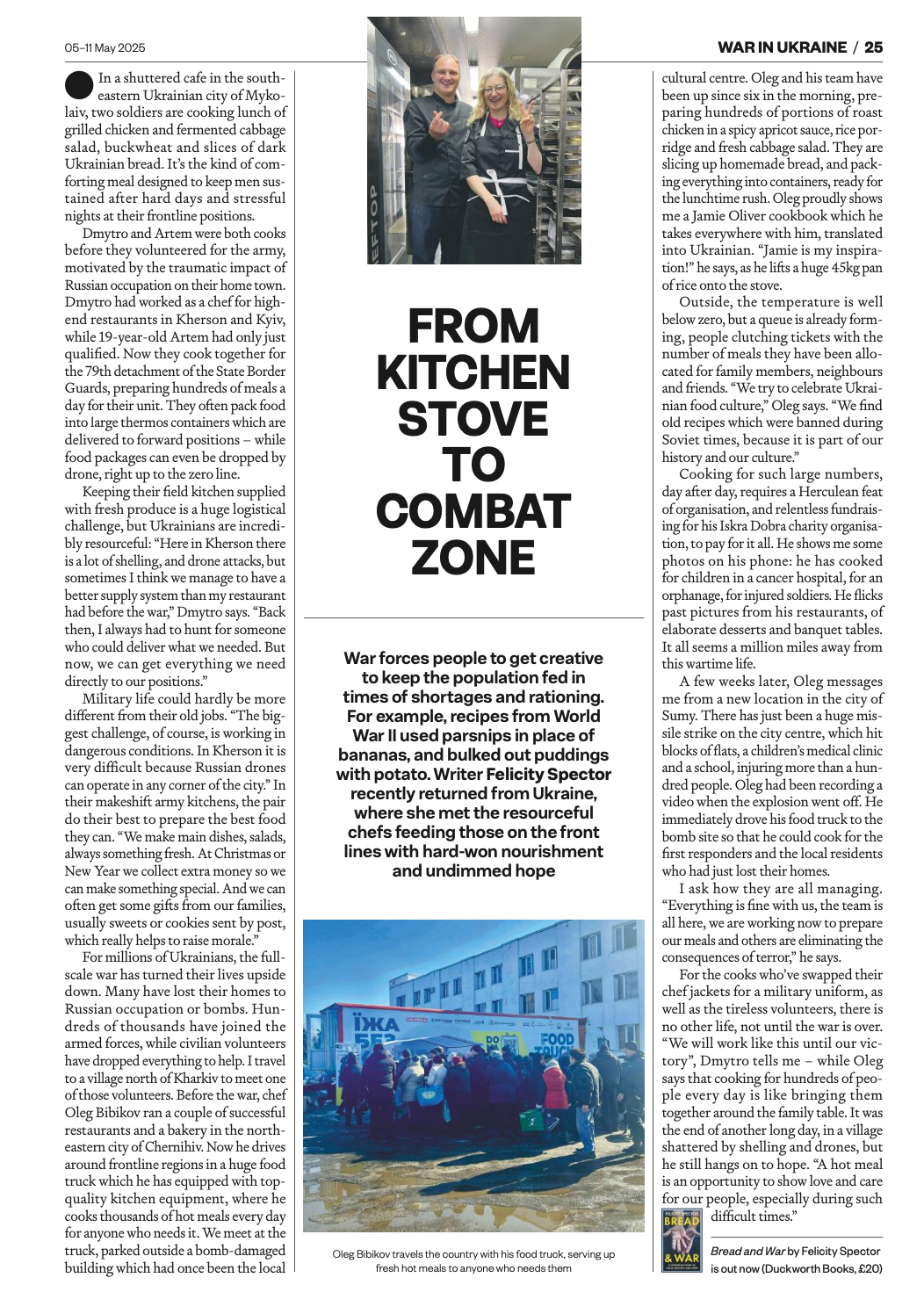 Photo of two smiling people, a man and a woman, standing in a kitchen or bakery, holding baked goods, with shelves of bread and food behind them.