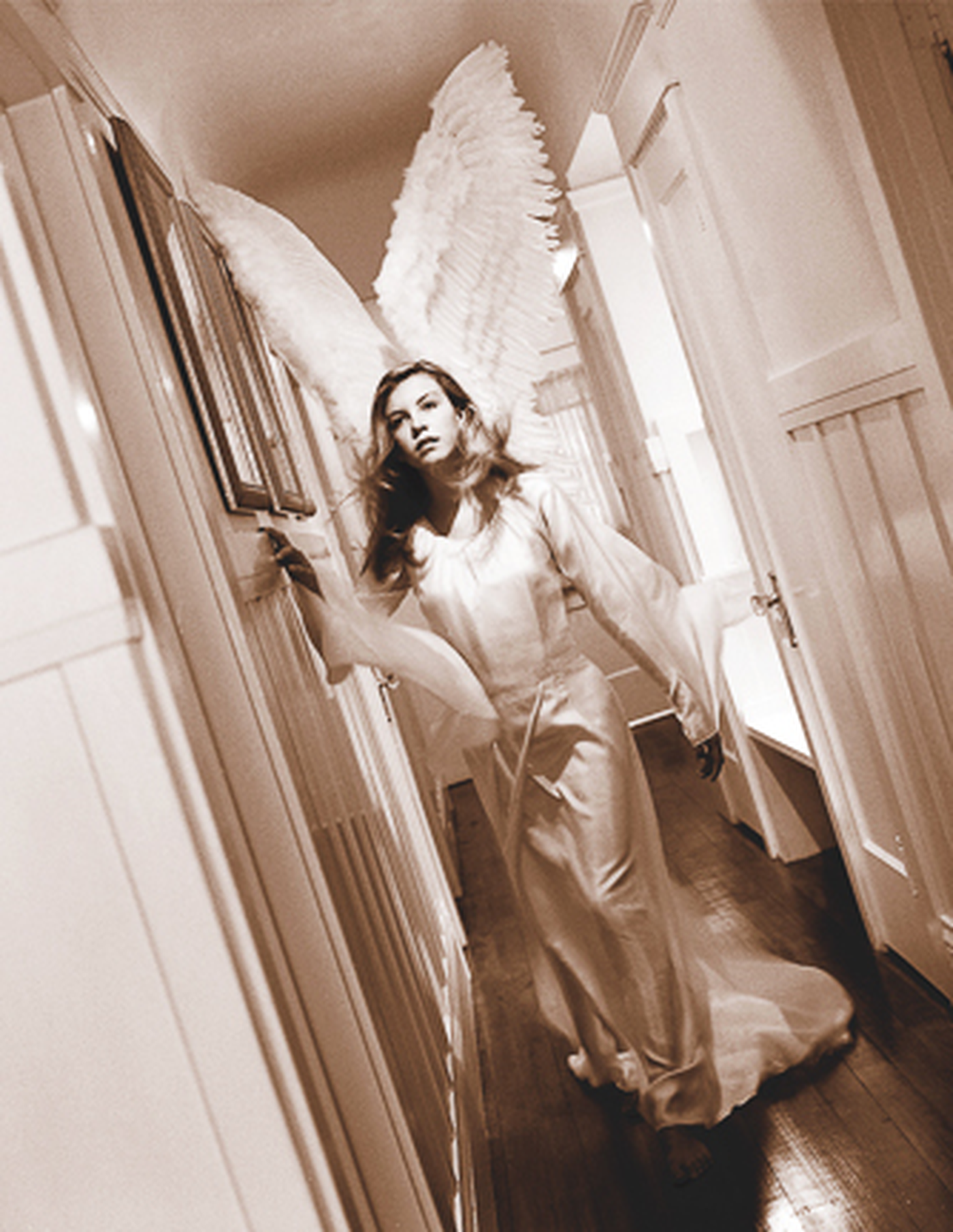 Savior by Kerry Swank featuring an angelic figure walking through a quiet hallway, symbolizing faith, protection, spiritual guidance, healing, hope, and God’s comforting presence through life’s journey.