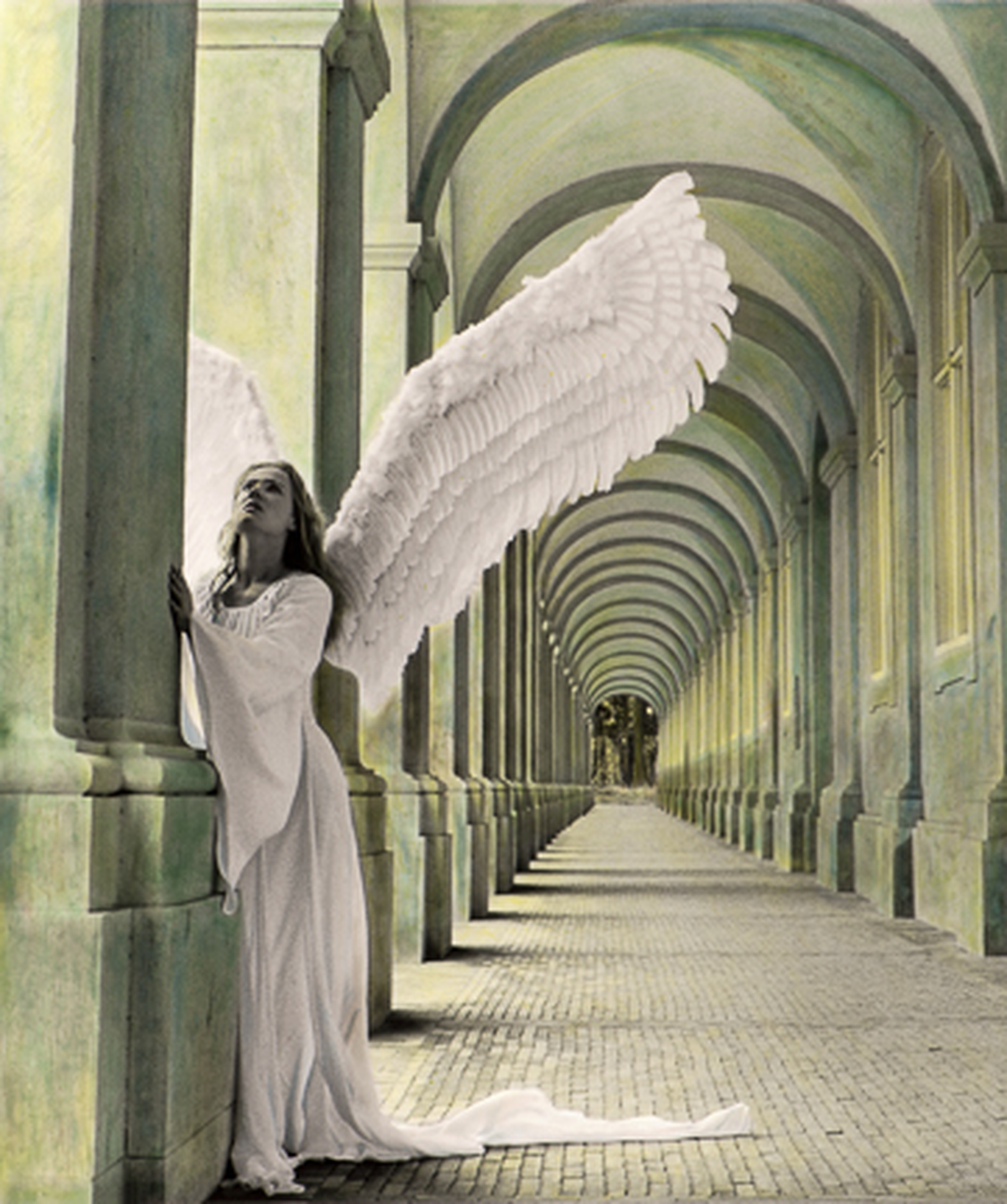 A woman with angel wings standing in an arched corridor, wearing a long white dress, with her hands raised in prayer.