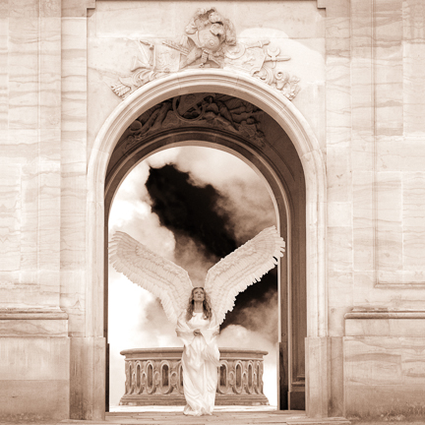 A statue of an angel with open wings stands on a balcony within an ornate archway, with clouds and dark smoke in the sky behind it.