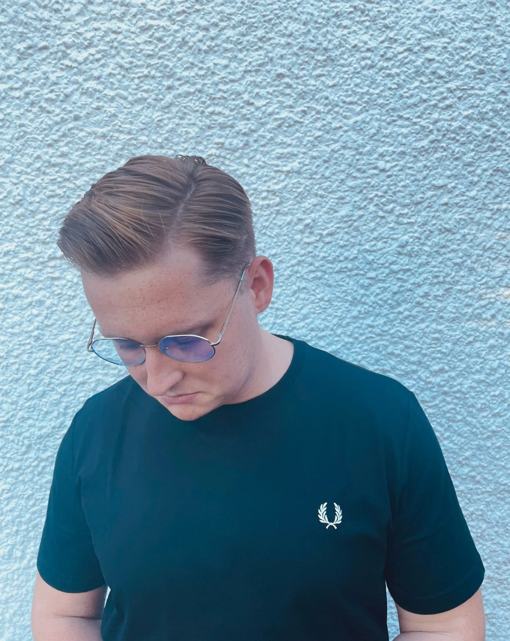 comedy poet wearing black fred perry t shirt