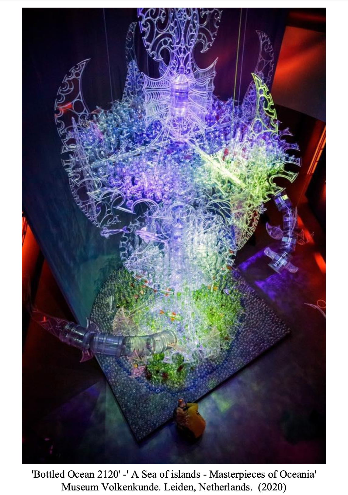 Colorful glass installation titled 'Bottled Ocean 2120' depicting a sea of islands with vibrant lights at Museum Volkenkunde in Leiden, Netherlands, from 2020.