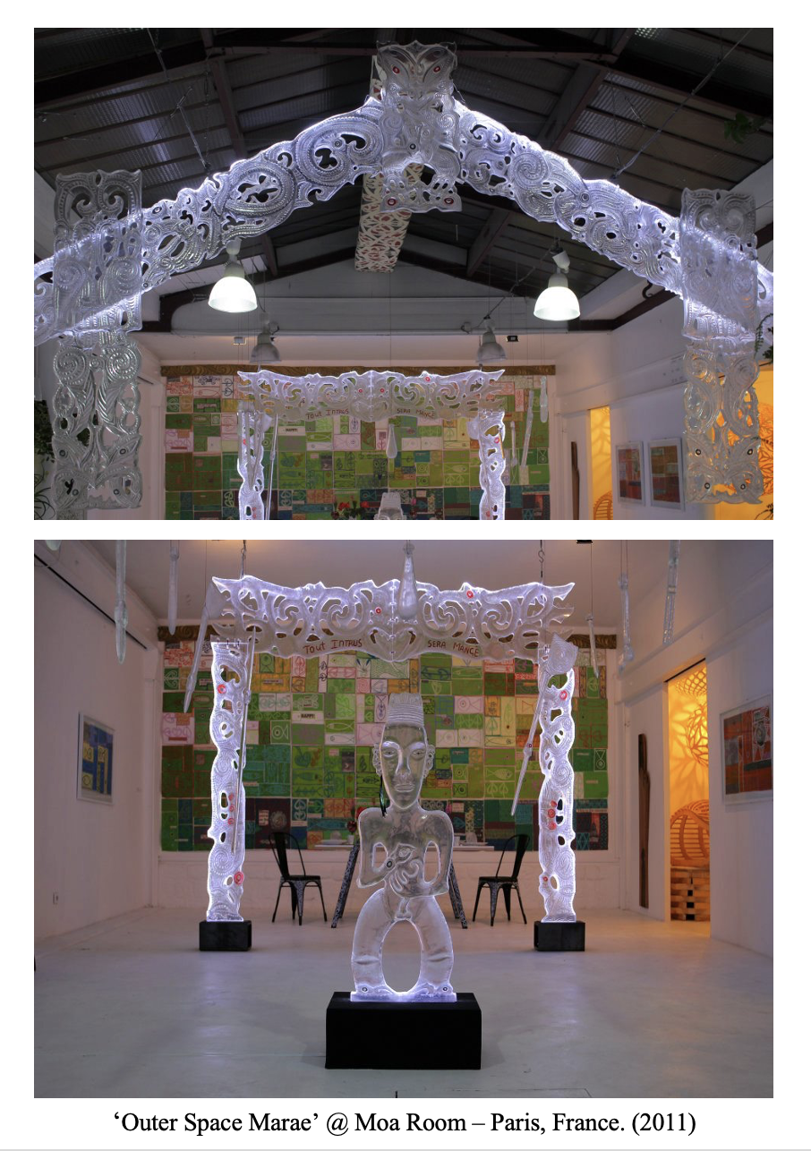 An art installation titled 'Outer Space Marae' at Moa Room in Paris, France, 2011, featuring illuminated carved sculptures resembling mythological or cultural figures and structures, with a colorful background installation and white walls.