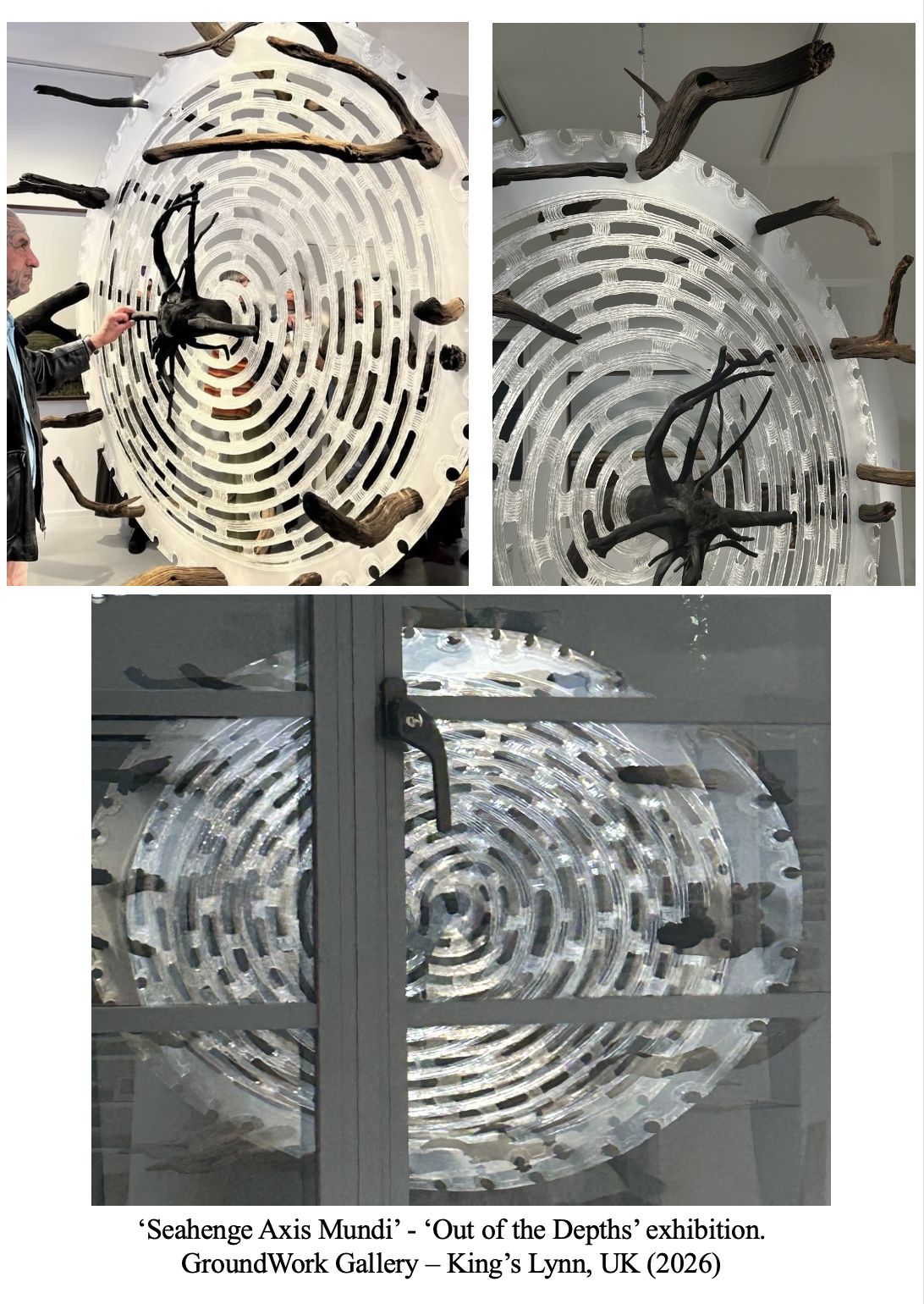 Installation artwork titled 'Seahenge Axis Mundi' from the 'Out of the Depths' exhibition at GroundWork Gallery, King’s Lynn, UK, 2026. The piece features a circular, maze-like overlaid structure with driftwood protrusions, viewed from various angles, including through a glass door.