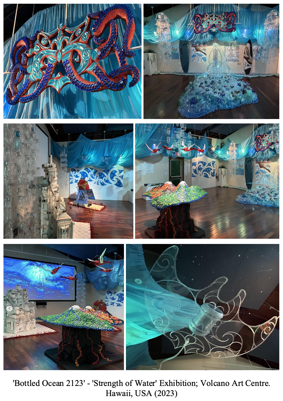 Exhibition room with ocean-themed art installations, including large sculptures of umbrellas covered in colorful bottle caps, hanging fish sculptures, and intricate sea shell and wave patterns. Blue fabric drapes and lighting evoke underwater scenes at the 'Bottled Ocean 2123' - 'Strength of Water' Exhibition at Volcano Art Centre, Hawaii, 2023.