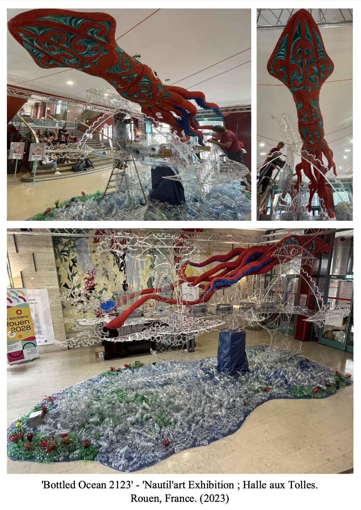 A sculptural art installation called 'Bottled Ocean 2123' at the Nautil'art Exhibition in Rouen, France, 2023, featuring large red and blue tentacle-like structures made of glass and fabric, resembling an ocean scene with bottles and plastic debris on the base.