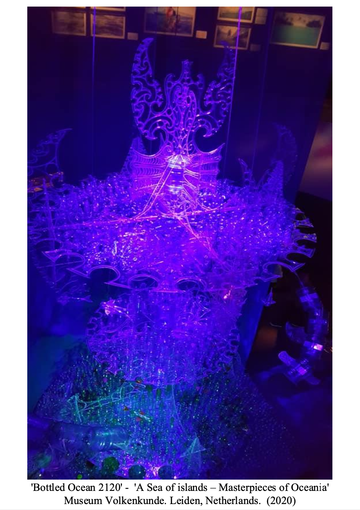 Glowing, intricate light sculpture titled 'Bottled Ocean 2120' resembling a sea of islands with purple and blue LEDs, displayed at Museum Volkenkunde in Leiden, Netherlands.