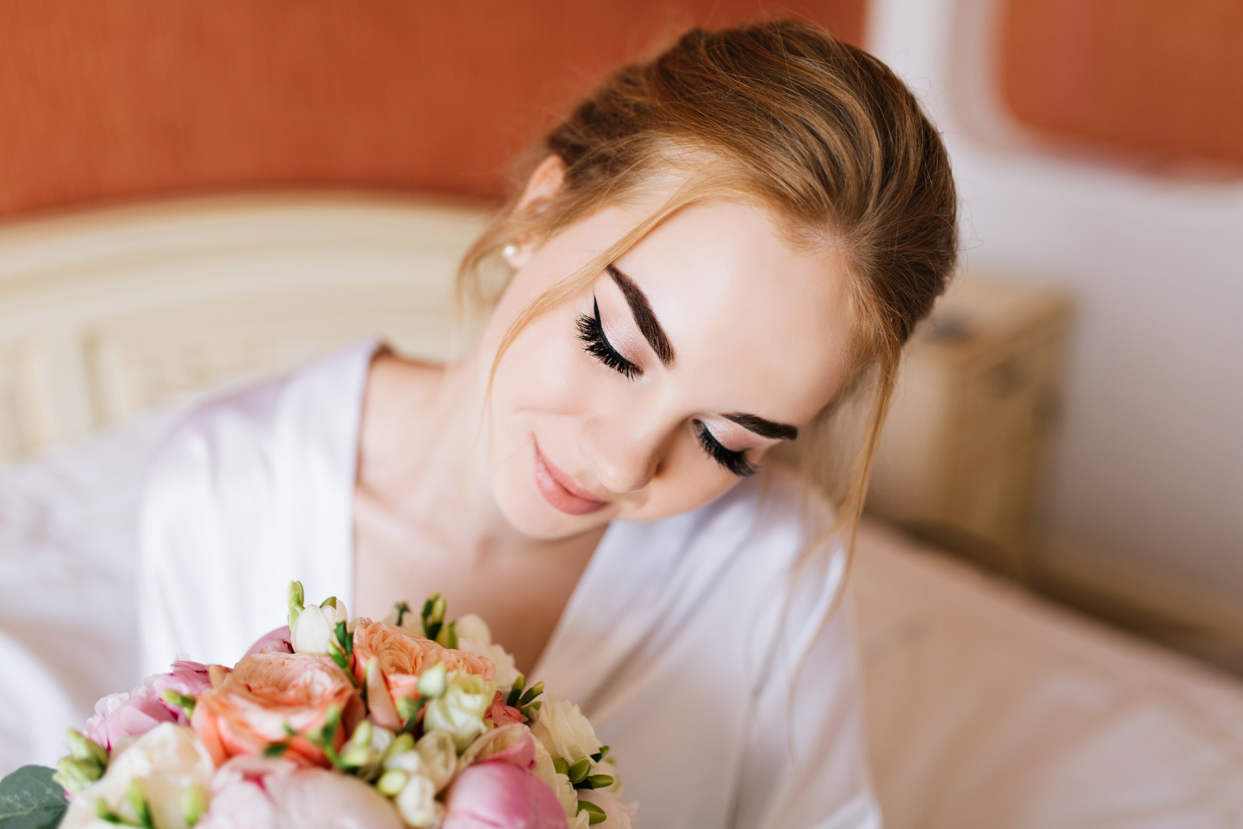 closeup-portrait-pretty-happy-bride-white-bathrobe-morning-appartment-she-looks-bouquet-flowers-hands-smiling.jpg