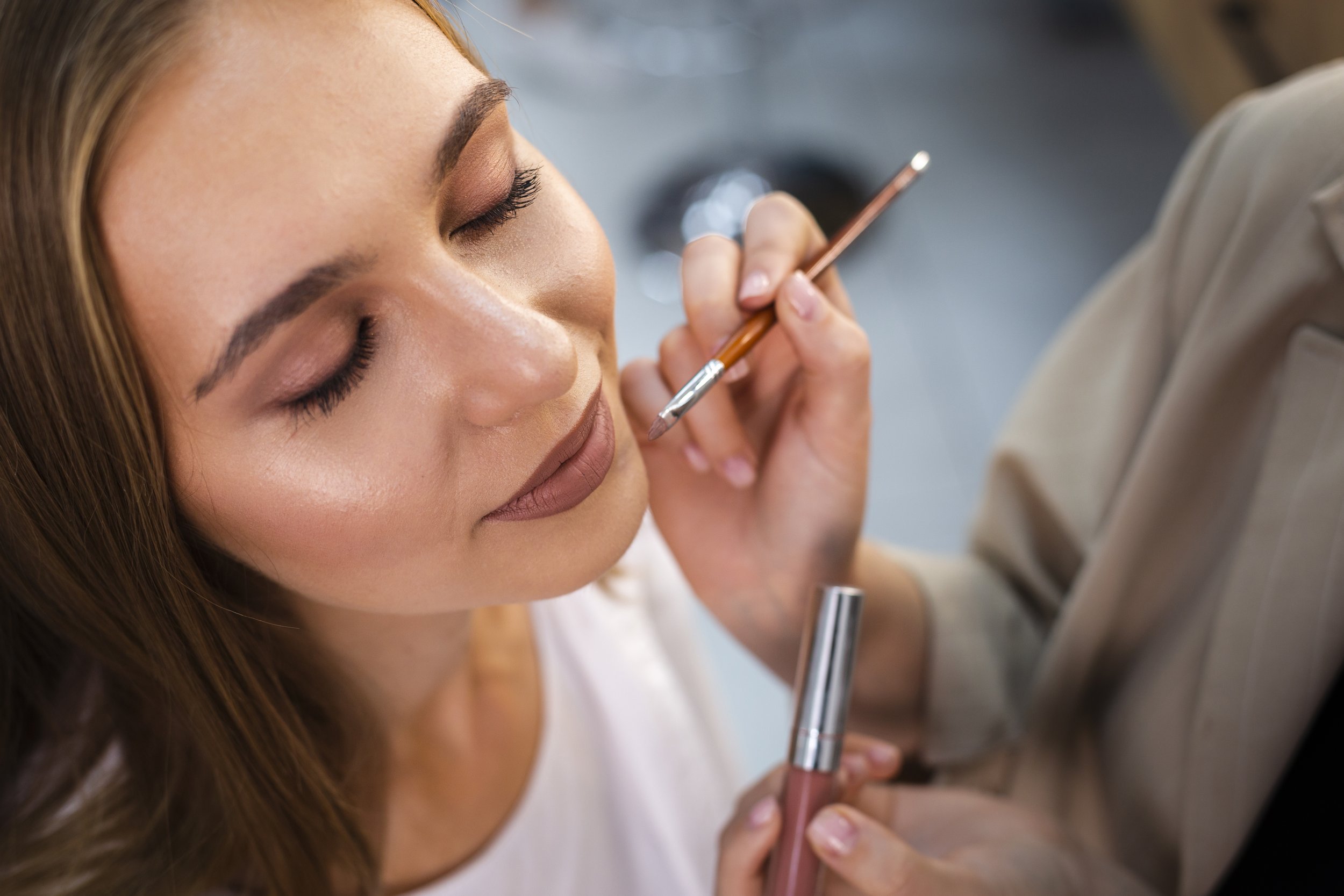 close-up-make-up-artist-applying-nude-lipstick-woman-with-brush.jpg