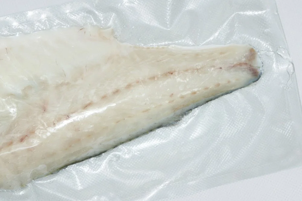 Fresh fish fillet on a plastic sheet.