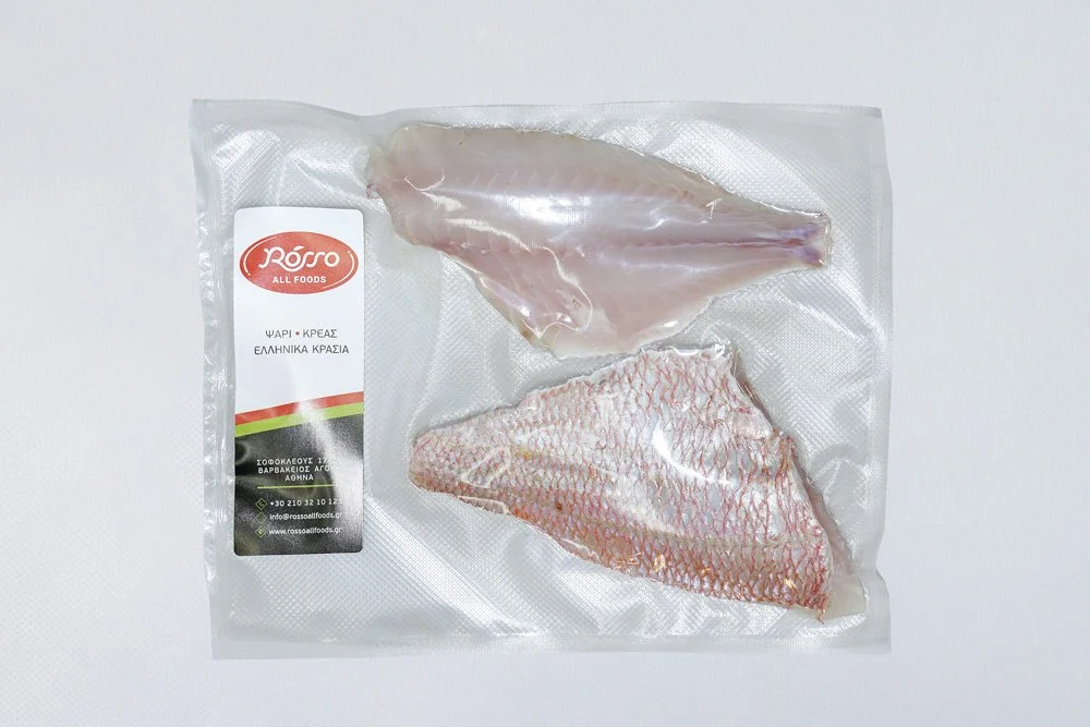Vacuum-sealed package of two fish fillets on a white surface.