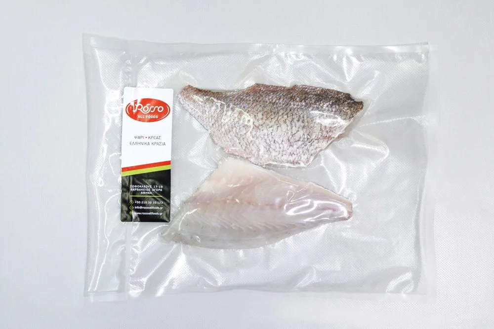 Vacuum-sealed package with two fish fillets, one with skin, from Greek foods.