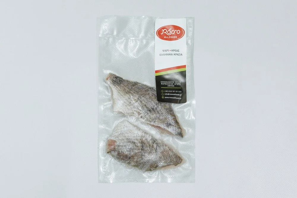 Two frozen fish fillets in a vacuum-sealed package with Rosso All Foods label that includes contact information and a description in Greek and English.