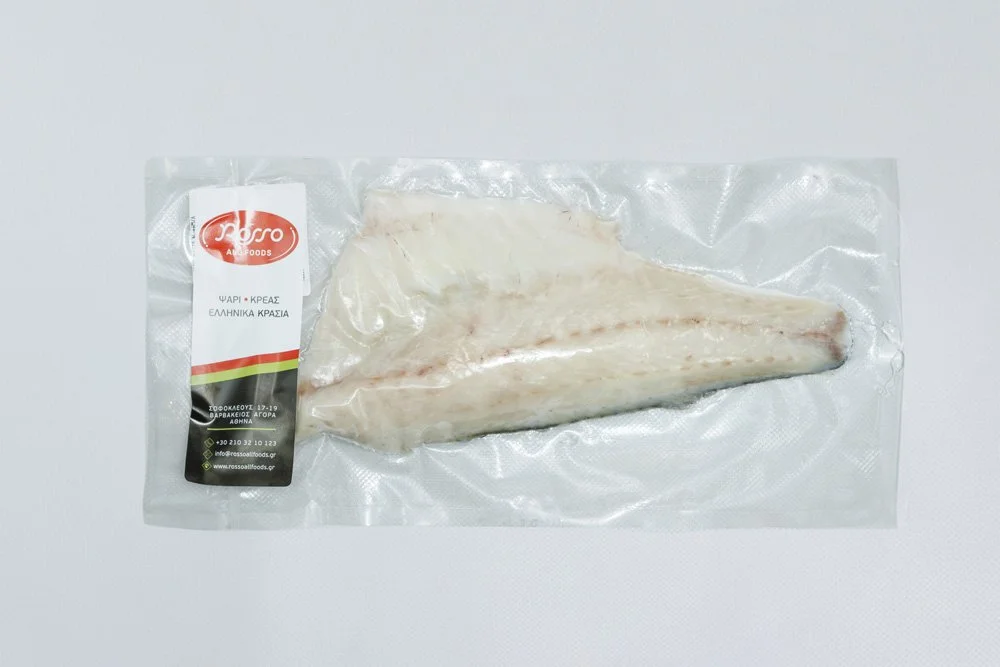 Frozen fish fillet in vacuum-sealed plastic packaging with label