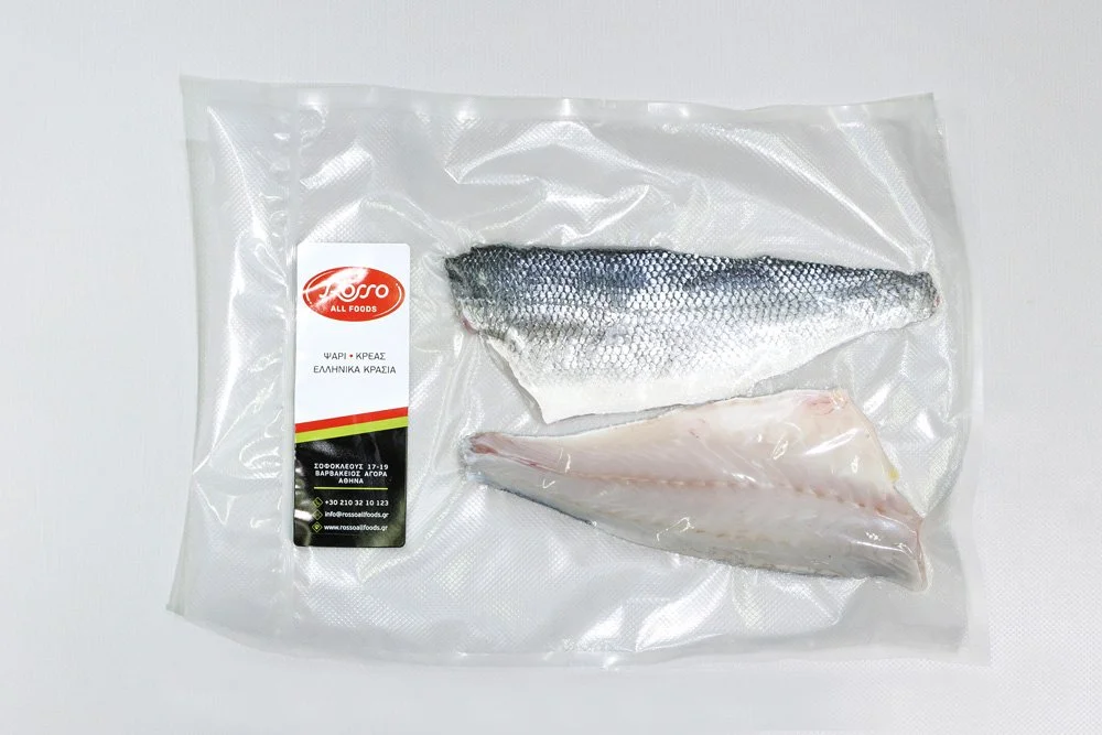 Two frozen fish fillets in a clear plastic packaging with a label from Rossall Foods on a white surface.