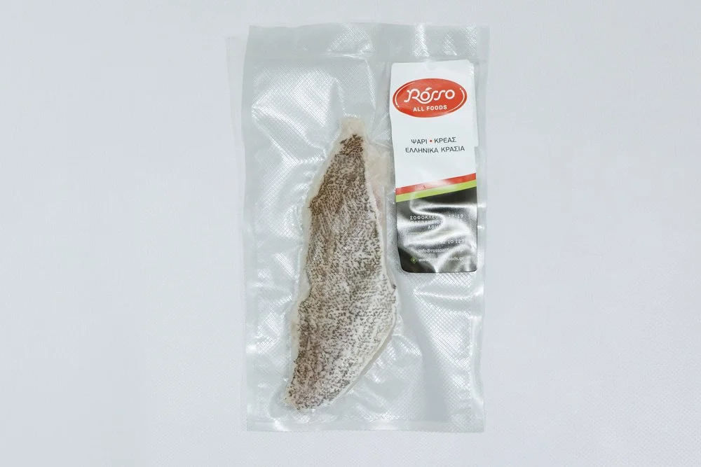 Frozen fish fillet in vacuum packaging with a label that reads "Roso All Foods" and Greek text indicating it is fish and meat, on a white background.