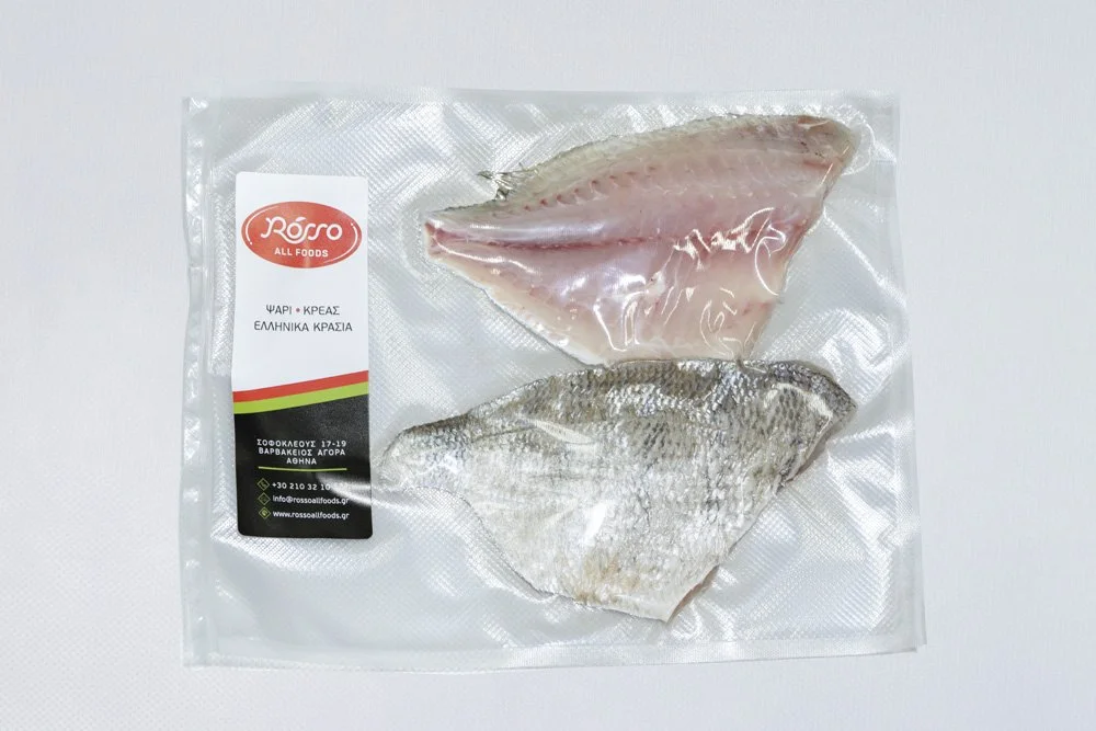 Two fish fillets in sealed vacuum packaging on a white surface, with a label on the packaging.